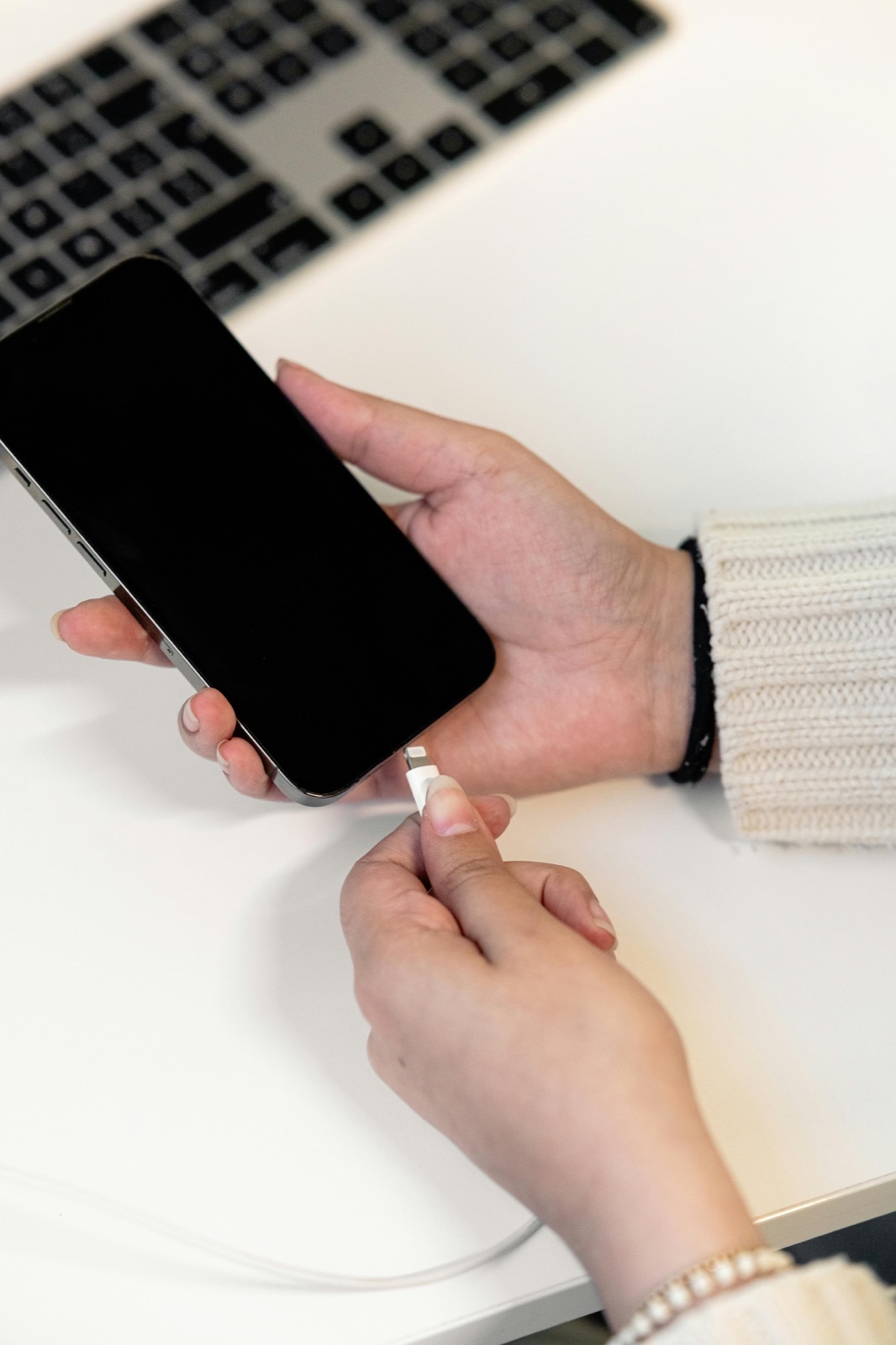 Charging cable connected to smartphone during charging-port troubleshooting