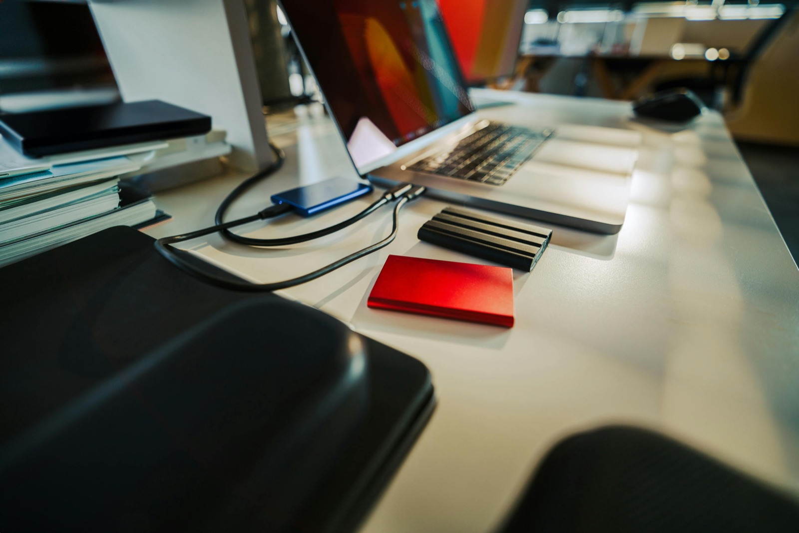 Laptop connected to external drives during file backup before device repair