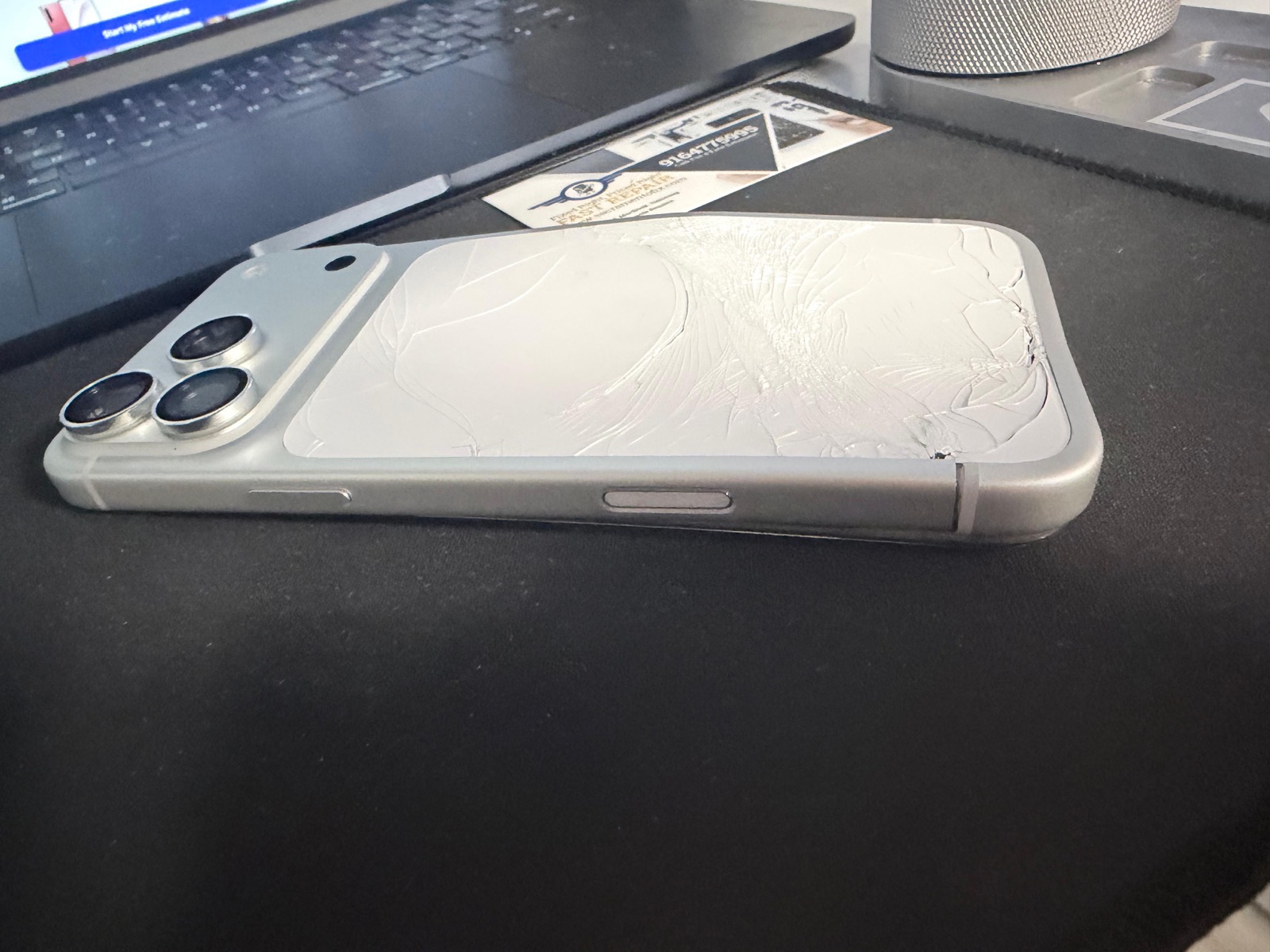 Back of iPhone 17 Pro Max before repair with severe impact damage