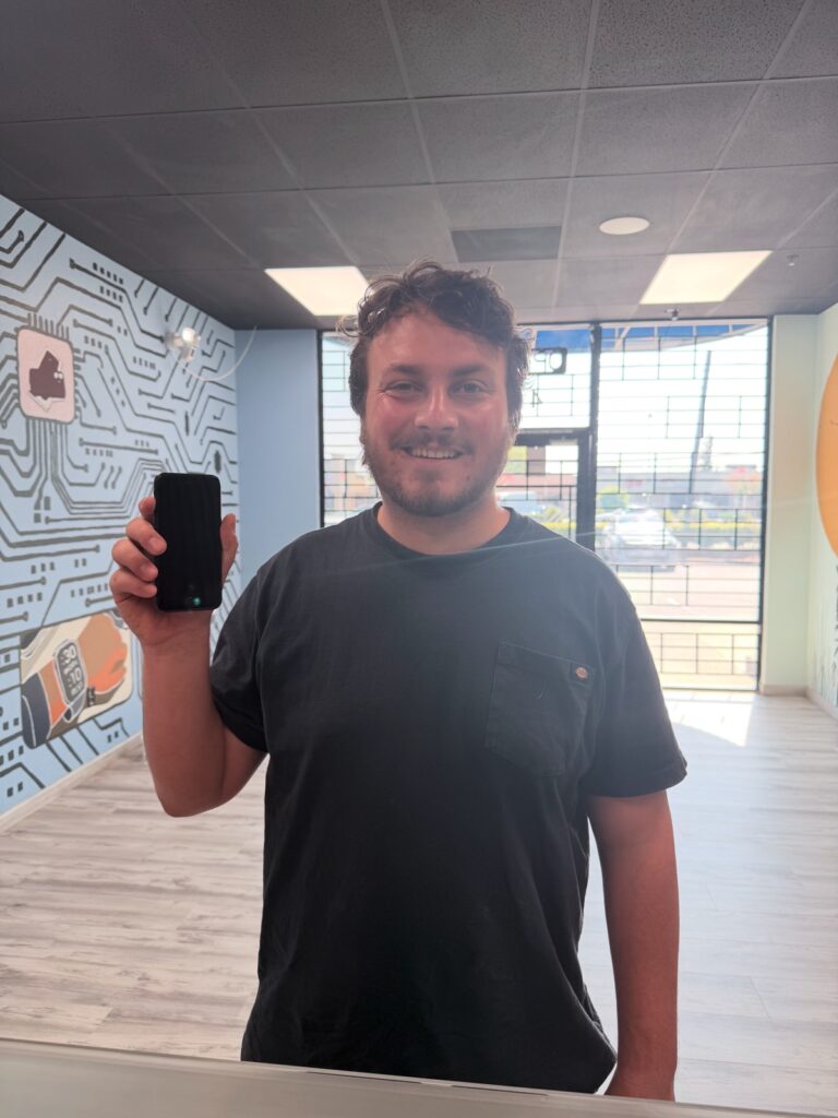 Jackson holding his working iPhone 8 after water damage repair at Fast Repair in Sacramento